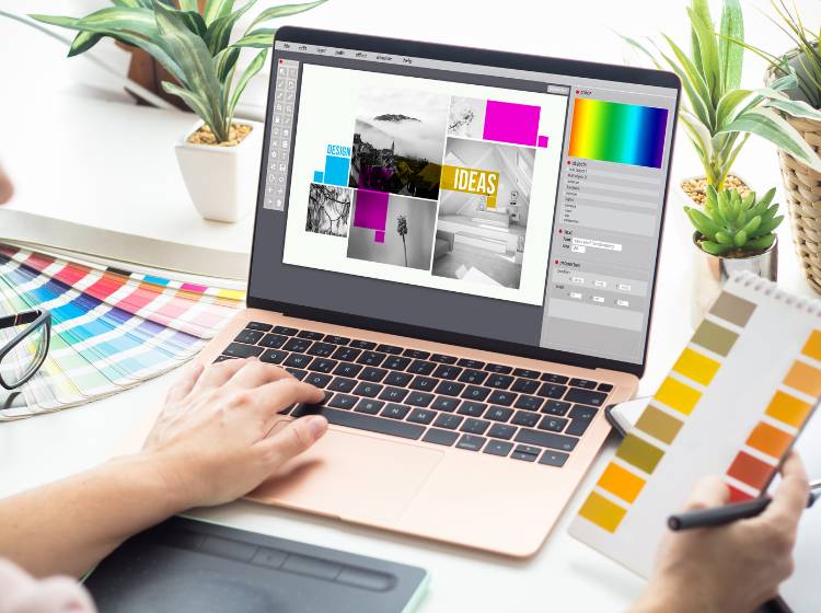 A person works on a laptop, designing a colorful collage