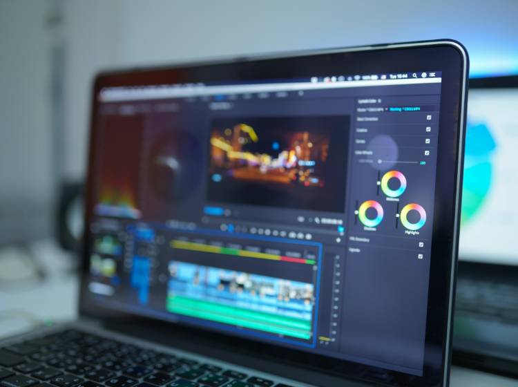 Laptop screen displaying a video editing software interface.